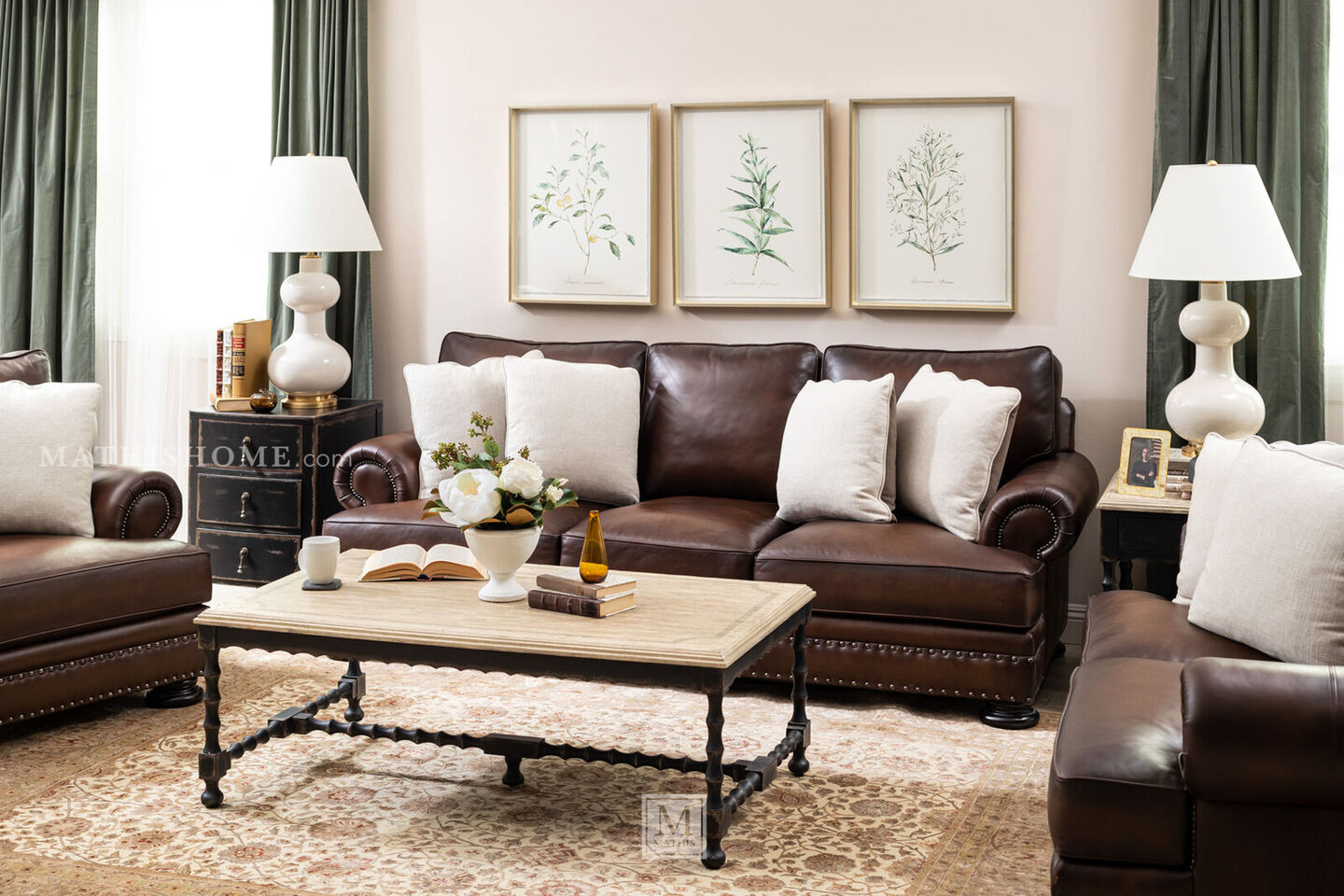 living room with dark brown couch, white lamps, and a tan coffee table